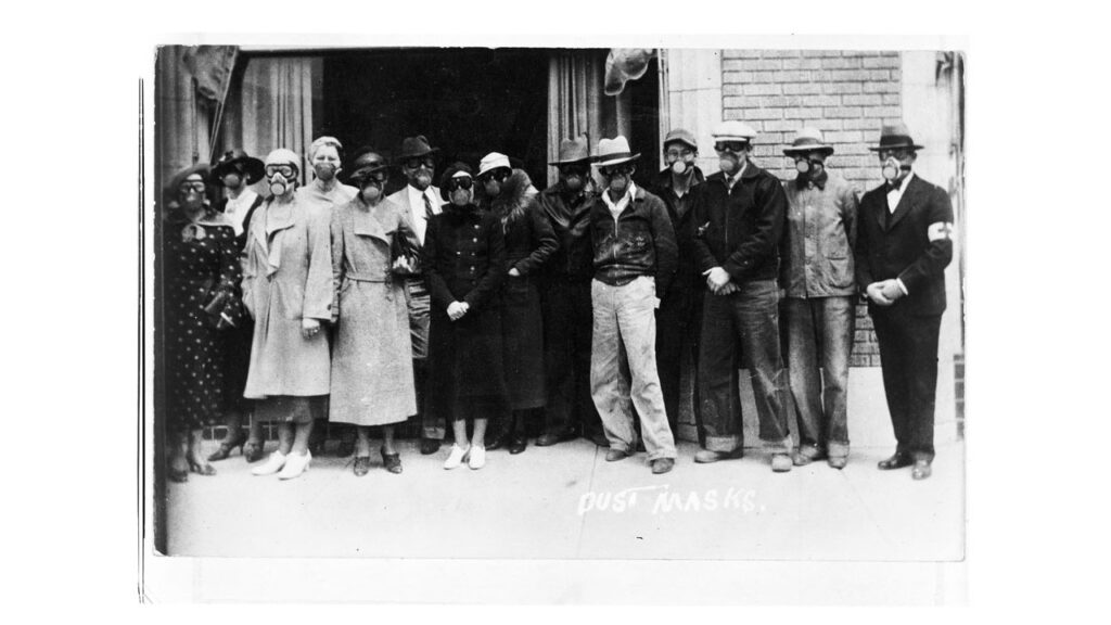 Image of people in front of a Kansas Red Cross Building wearing gas masks, 1935